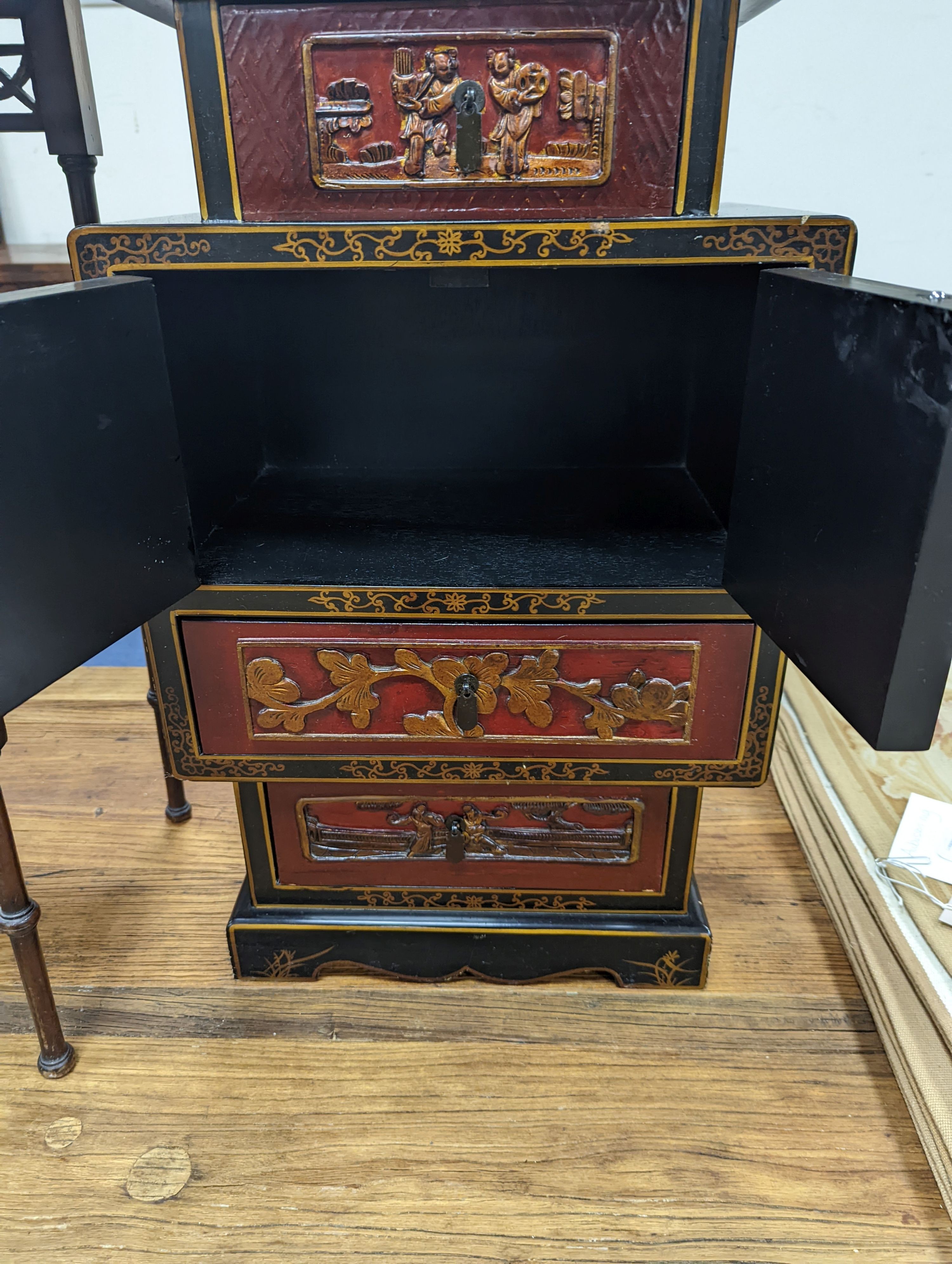 A late 19th century Chinese red and black lacquered cabinet, width 39cm, height 66cm